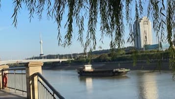 A river with a bridge and a boat.