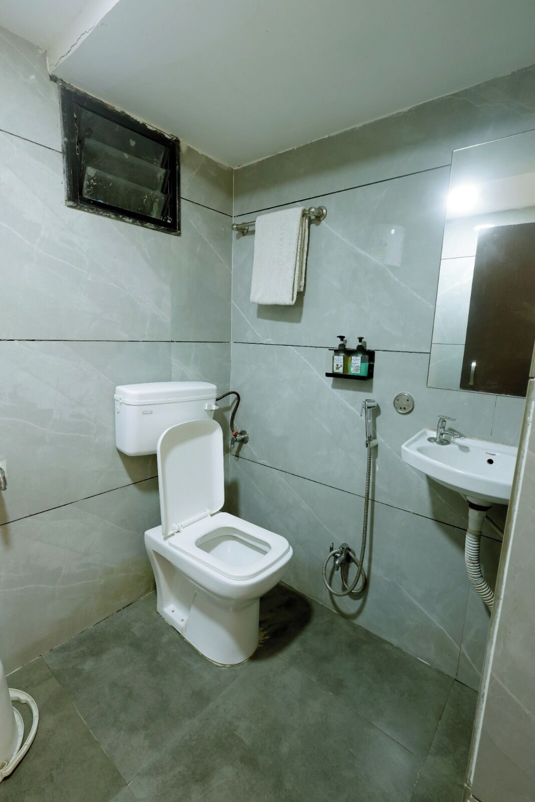 A bathroom with a toilet, a sink, and a shower.