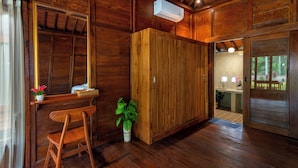 A wooden interior with a desk, chair, and potted plant.