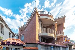 A multi-story building with a balcony on the second floor.