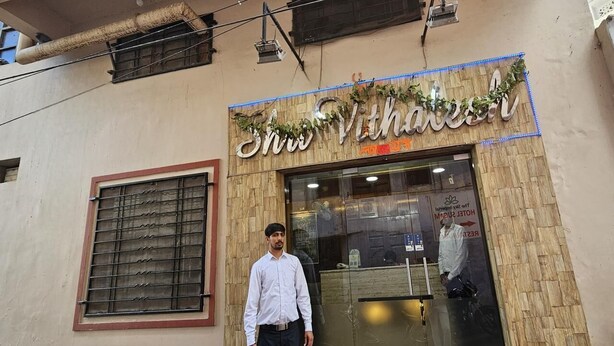 A hotel entrance with a sign reading "Shri Vithalashram" and a visible reception desk. - Hotel Shri Vithalesh (Nathdwara)