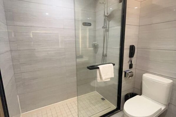 A modern bathroom with a glass-enclosed shower, a toilet, and a telephone. - Yurong International Hotel (Kunshan)