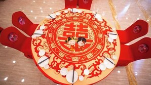 A round table with a traditional Chinese design, surrounded by red chairs with floral decorations. - Jinshui Hot Spring Hotel (Shen County)