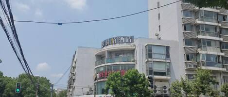A multi-story building with signage for a hotel and a medical facility.