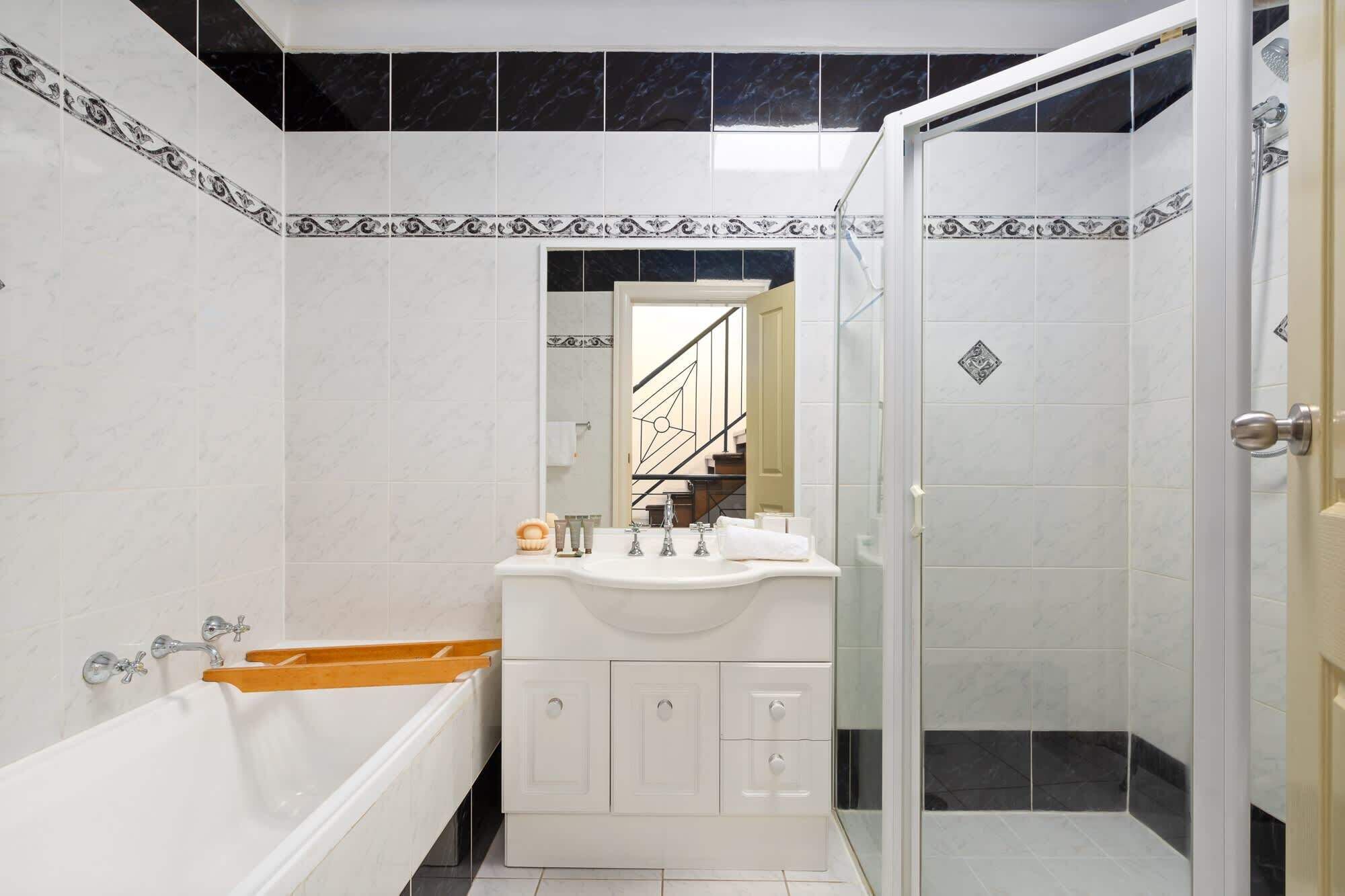 A bathroom with a bathtub, a sink, and a shower.