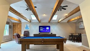 A pool table in a room with wooden beams, a television, and a map on the wall. - Waterfront Oasis~Pool Table~Deck~Dock~Garage (Dover)
