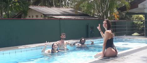 A swimming pool with people in the water.