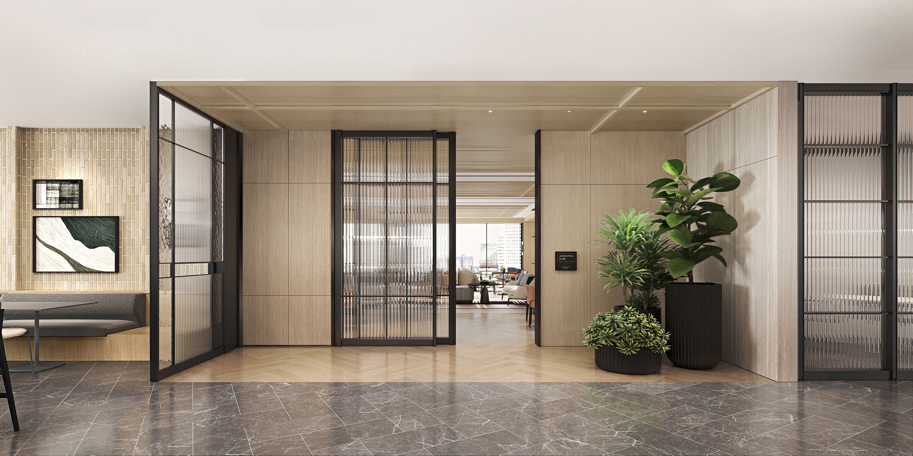 A modern interior with a seating area, a large potted plant, and a view into another room.