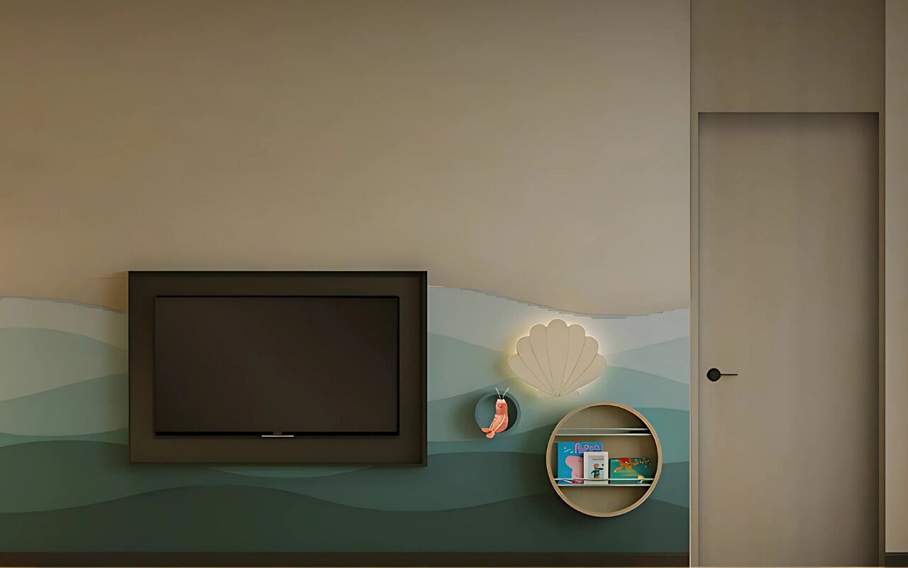 A wall-mounted television, a decorative shell, a small shelf with books, and a door.