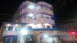 A multi-story building with a bar on the ground floor and a brightly lit upper level. - AG Residency (Port Blair)