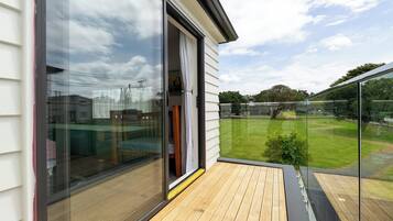 Enjoy a serene view of the well-maintained lawn and sports field from this balcony.