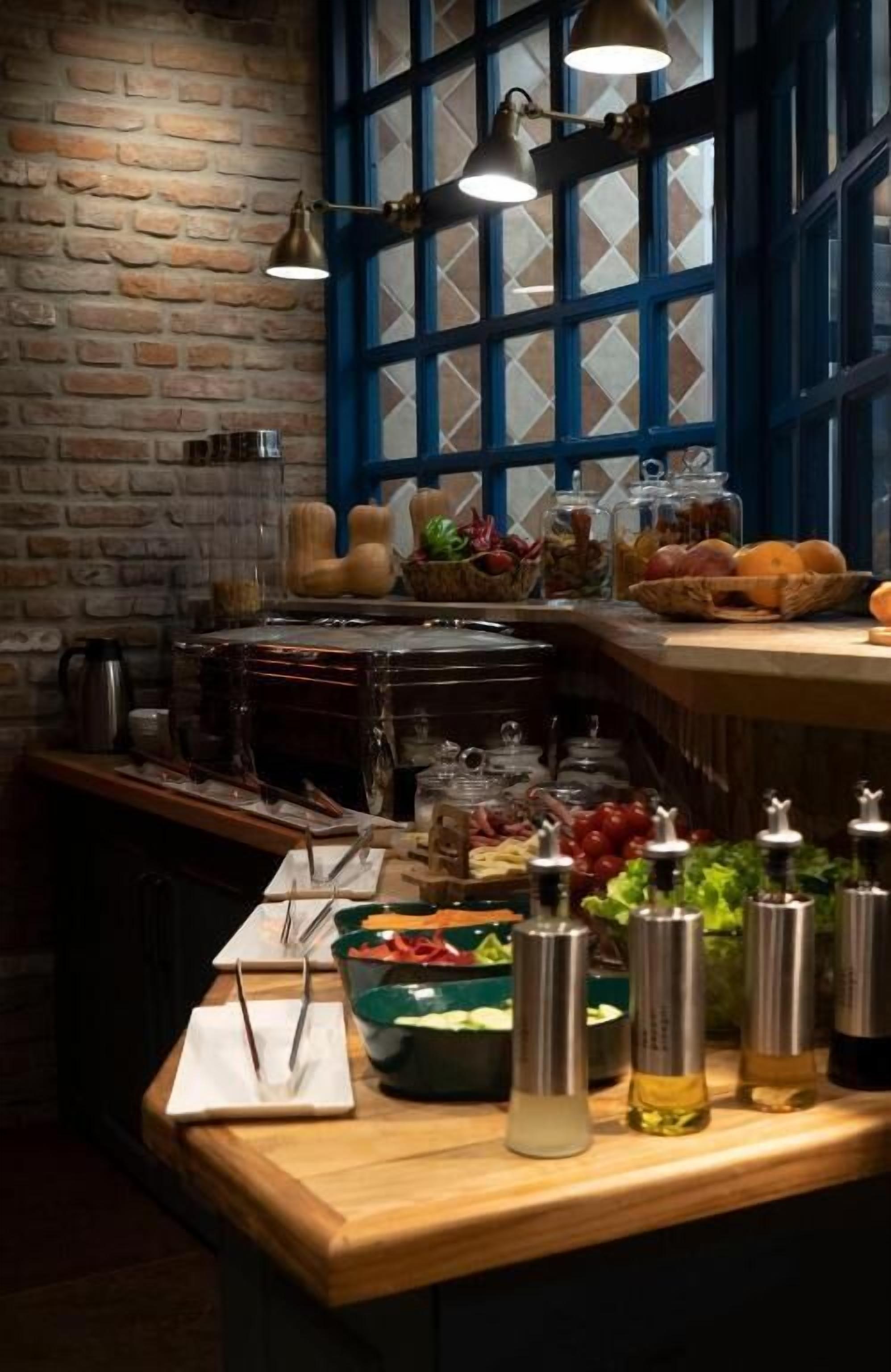 A buffet setup with various food items and condiments.