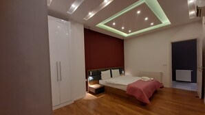 A modern bedroom with a bed, wardrobe, and a skylight. - Bagebi two bedroom beautiful view  (Tbilisi)