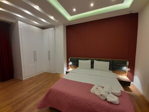 Relax in a serene space with a large bed, bedside tables, and ample storage in this stylish room.