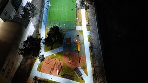 An aerial view of a sports field with a soccer goal, a playground, and surrounding buildings. - Bagebi two bedroom beautiful view  (Tbilisi)