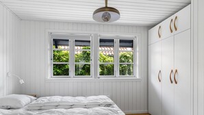 A bedroom with a bed, a window, and a wardrobe. - "Gravers" - 150m from the sea by Interhome (Svendborg)