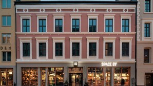 A multi-story building with a storefront labeled "SPACE BY". - Hobo Oslo (Oslo)
