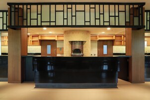 Una cocina moderna con una isla central, muebles de madera y una chimenea integrada.