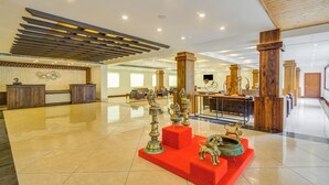 A spacious lobby with a polished tile floor, a reception desk, and a display of decorative items. - Club Mahindra Le Vintuna (Gangtok)