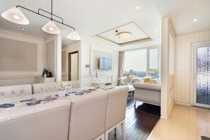 Deluxe Apartment, City View | Living area | 55-inch LED TV with cable channels, Netflix, streaming services - Luxury Condotel Luminous Leman (Ho Chi Minh City)