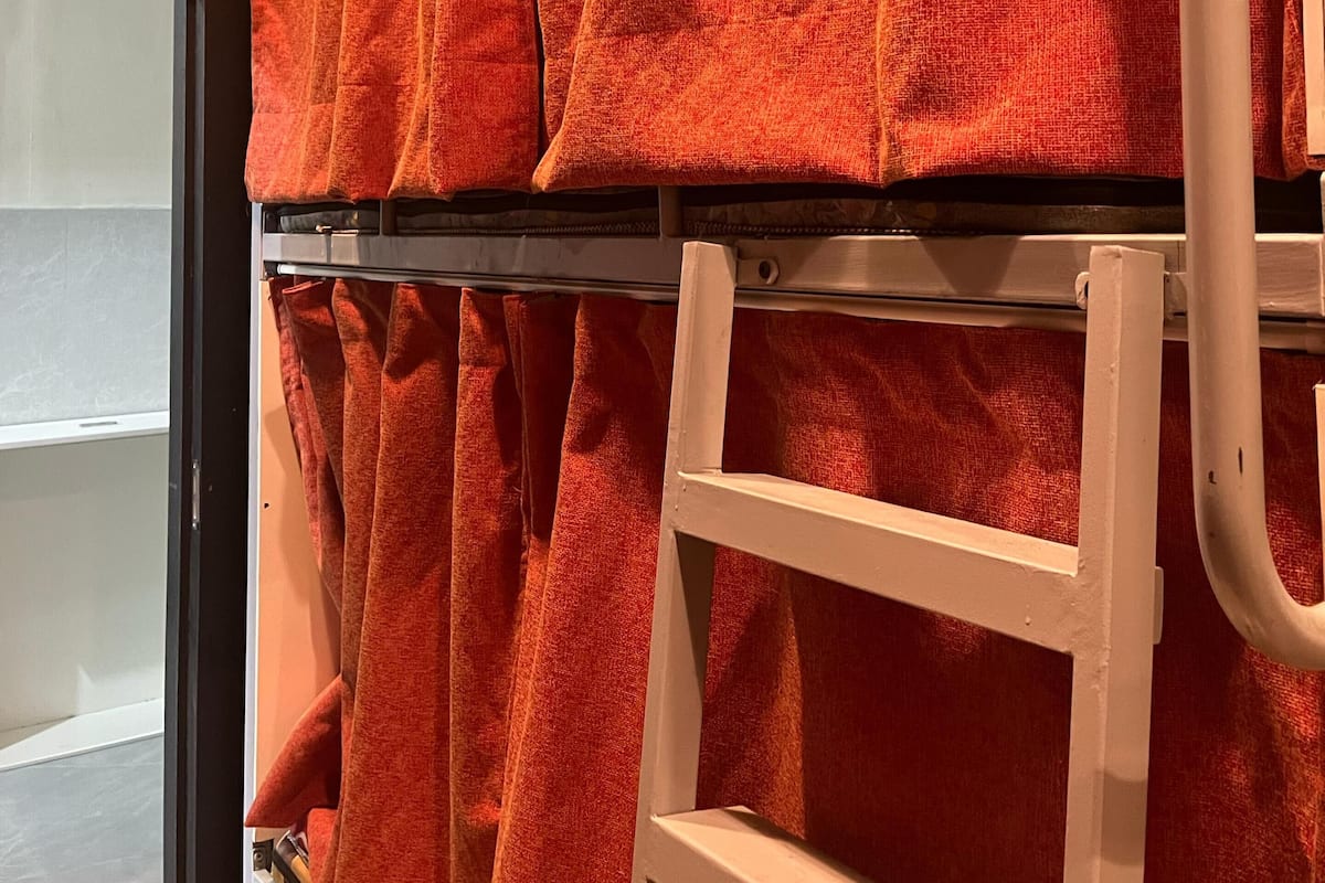 A storage rack with multiple orange towels.