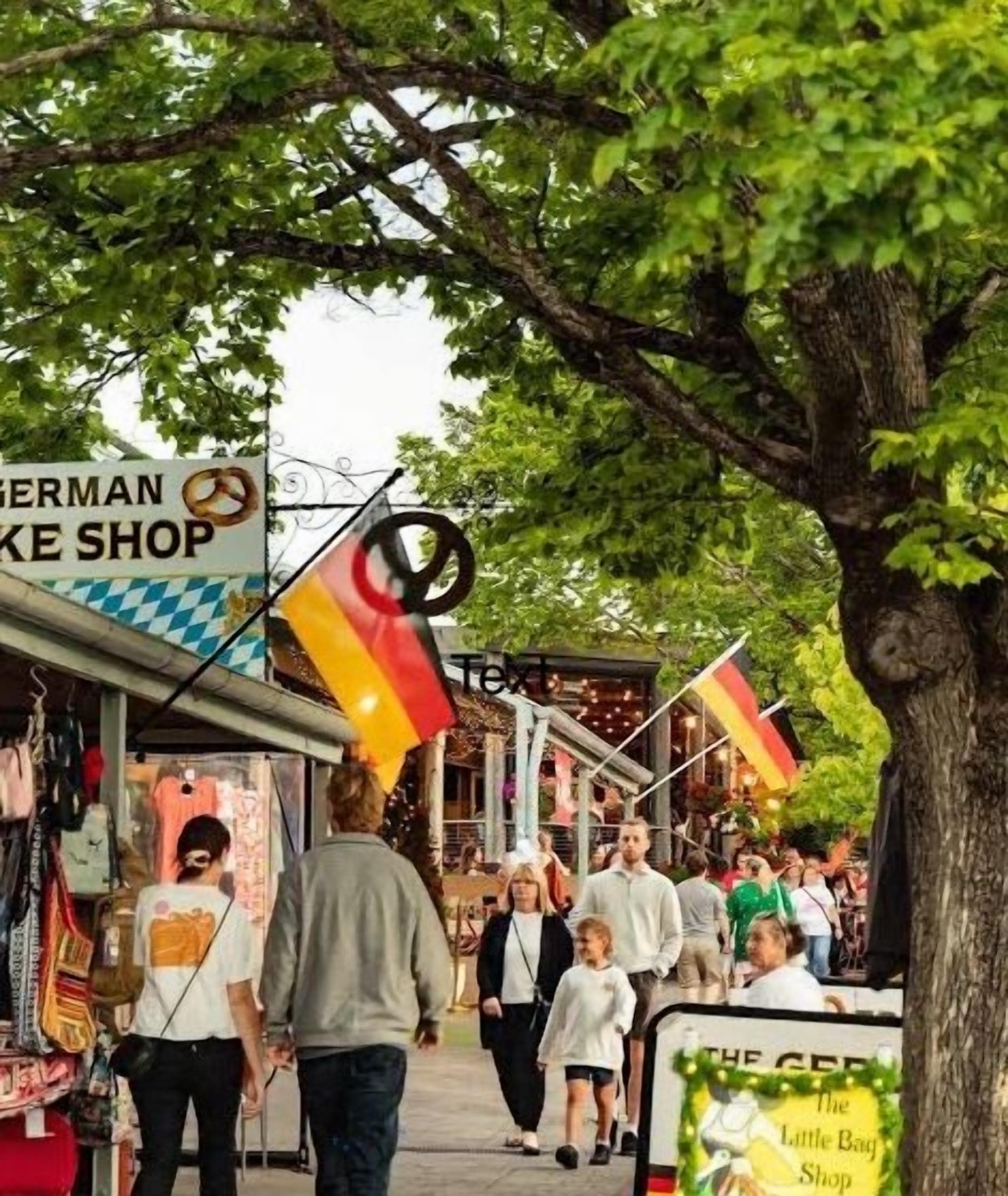 Una calle bordeada de comercios, incluyendo una panadería alemana y una tienda Little Bag.