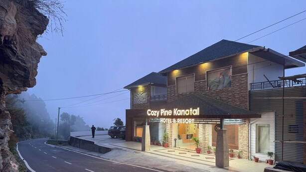 A hotel named Cozy Pine Kanatal with a modern design, featuring a stone facade and a well-lit entrance. - Cozy Kanatal Hotel And Resort (Tehri)