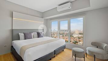 A modern bedroom with a large bed, a view of the city, and a window.