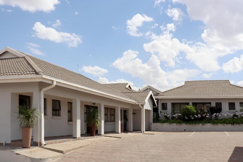 A building with a tiled roof and a covered walkway.