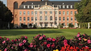 A large, historic building with a symmetrical facade, multiple windows, and a central entrance with decorative elements. - Mosel-Herz Trier vacation home! Directly on the Moselle, 10 min to the city center  (Trier)