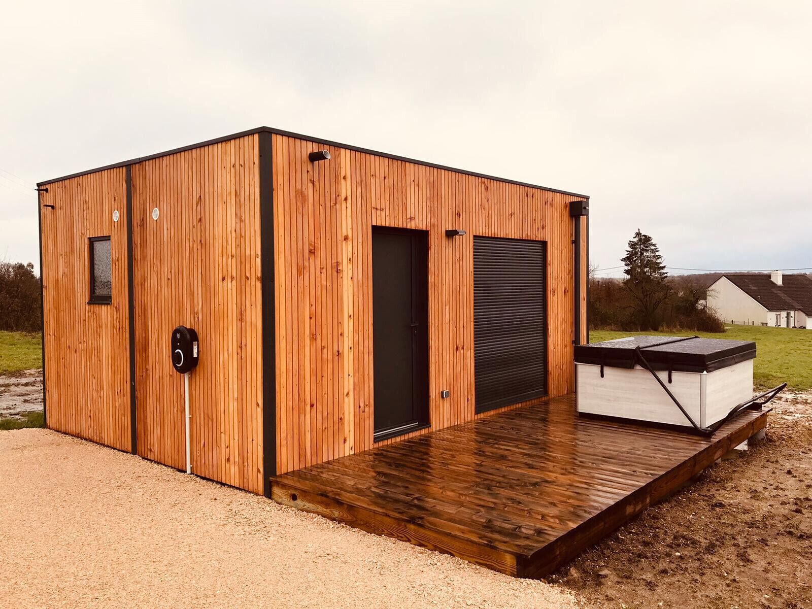 A wooden cabin with a door, a window, and a small deck.