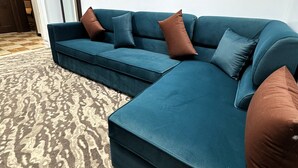 A sectional sofa with a patterned rug. - Eqamh Etlala Quba- إقامة إطلالة قباء (Madinah)