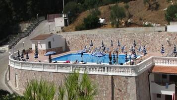 Seasonal outdoor pool, pool umbrellas, pool loungers