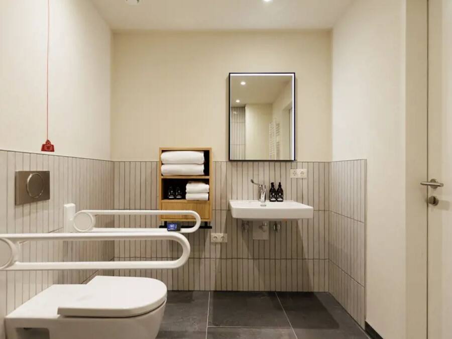 A modern bathroom with a toilet, bidet, and sink.
