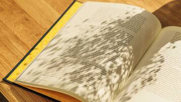 An open book on a wooden table.