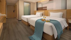 A hotel room with two beds, a wooden floor, a large window, and a wall-mounted TV. - Hualv Hotel (Guangzhou Children's Hospital Shangxiajiu Pedestrian Street Branch) (Guangzhou)