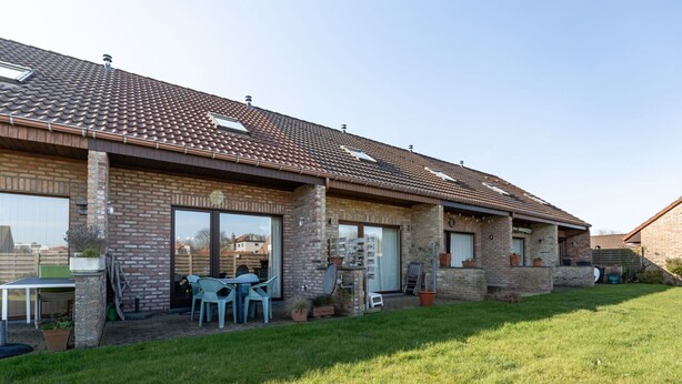 A two-story house with a tiled roof, brick walls, and a grassy yard. - Wonderful  villa for 4 people with WIFI and TV (Bruges)