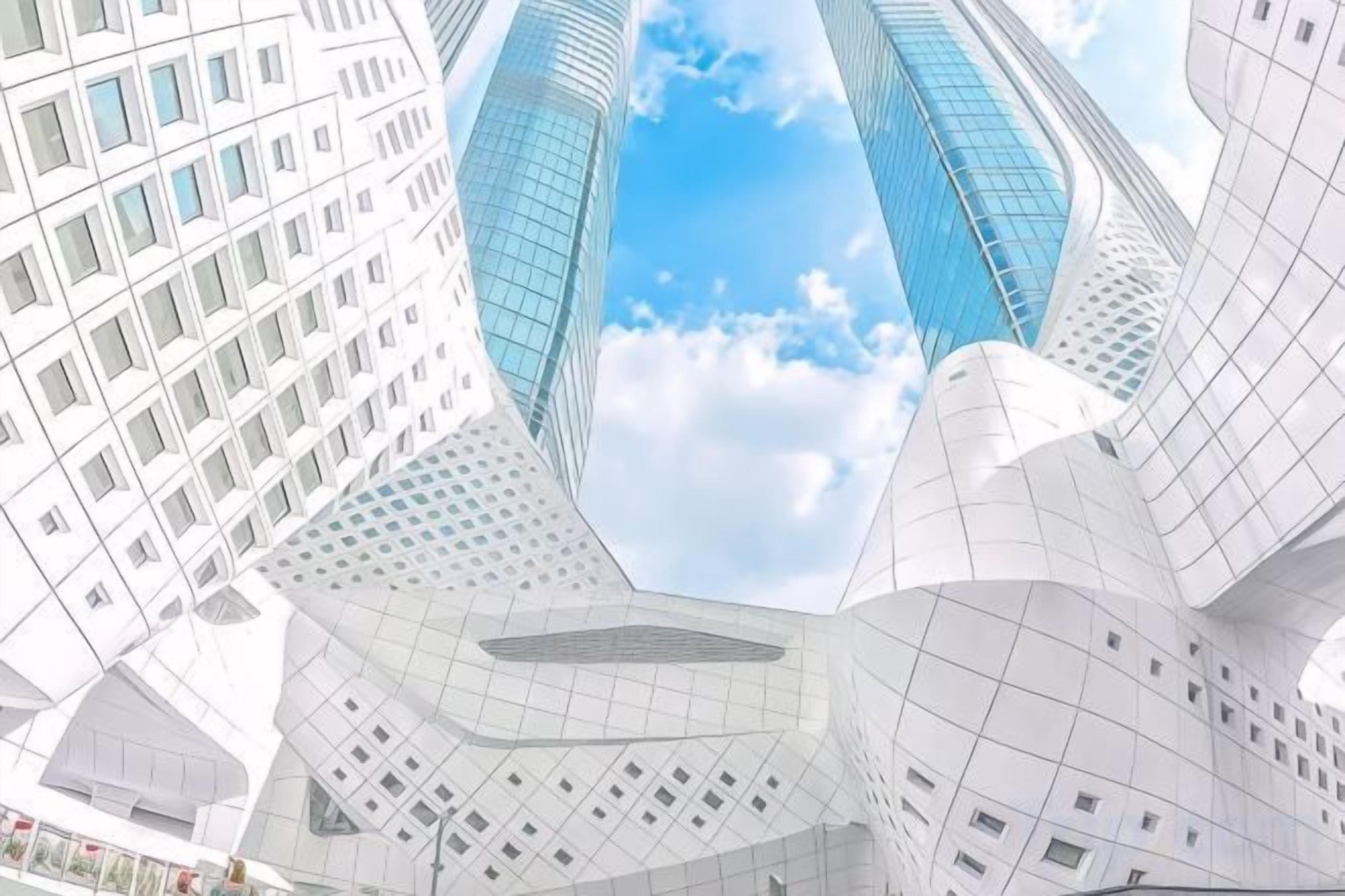 A modern building with a unique angular design, featuring multiple levels and a glass facade.