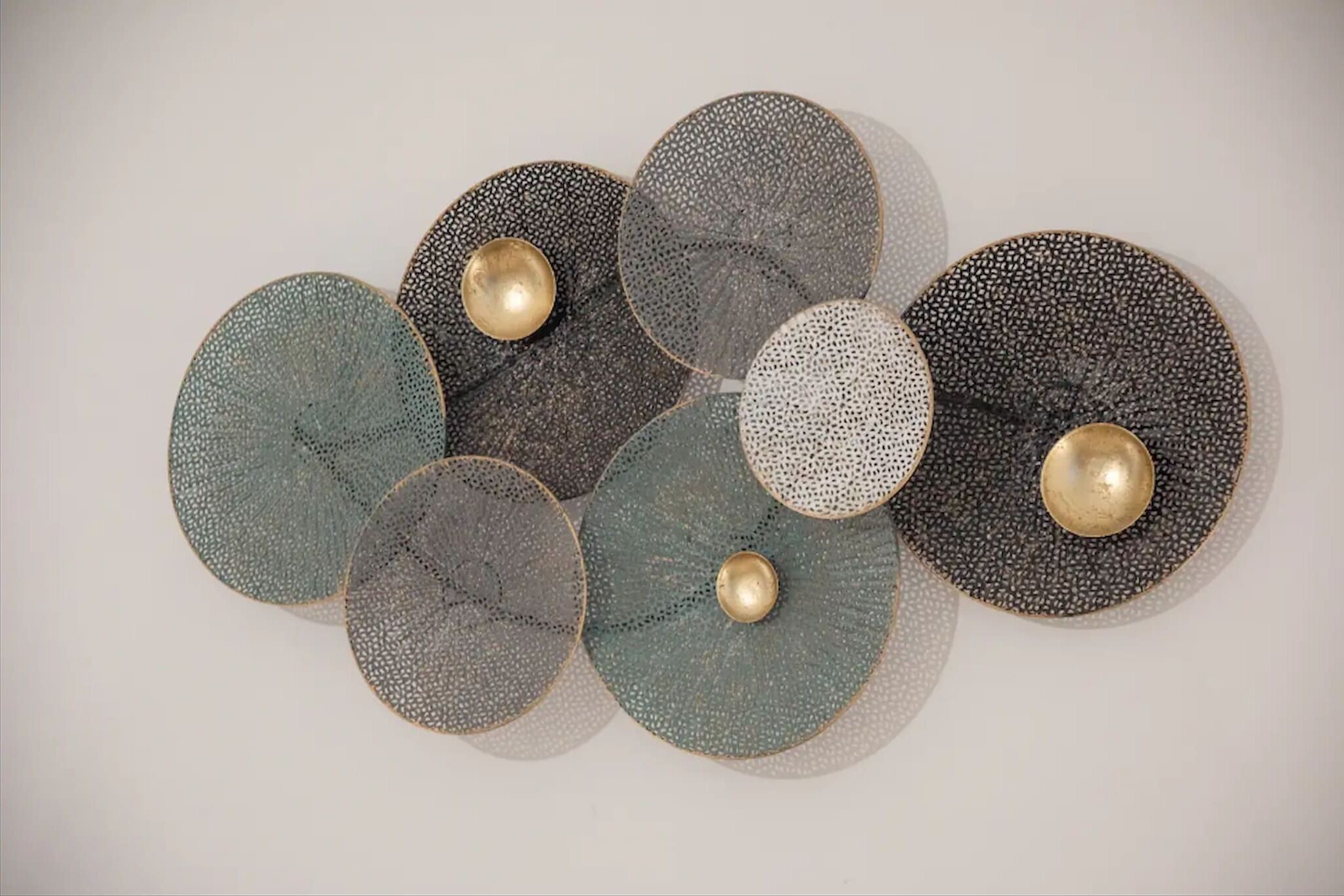 A wall with circular decorative plates of varying sizes and patterns.