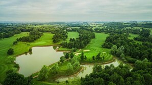 A golf course with multiple ponds, surrounded by dense trees and open grassy areas. - The Vale Golf and Country Club (Pershore)