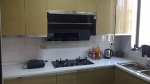 Une cuisine équipée d’une cuisinière à gaz, d’un four à micro-ondes et de placards.