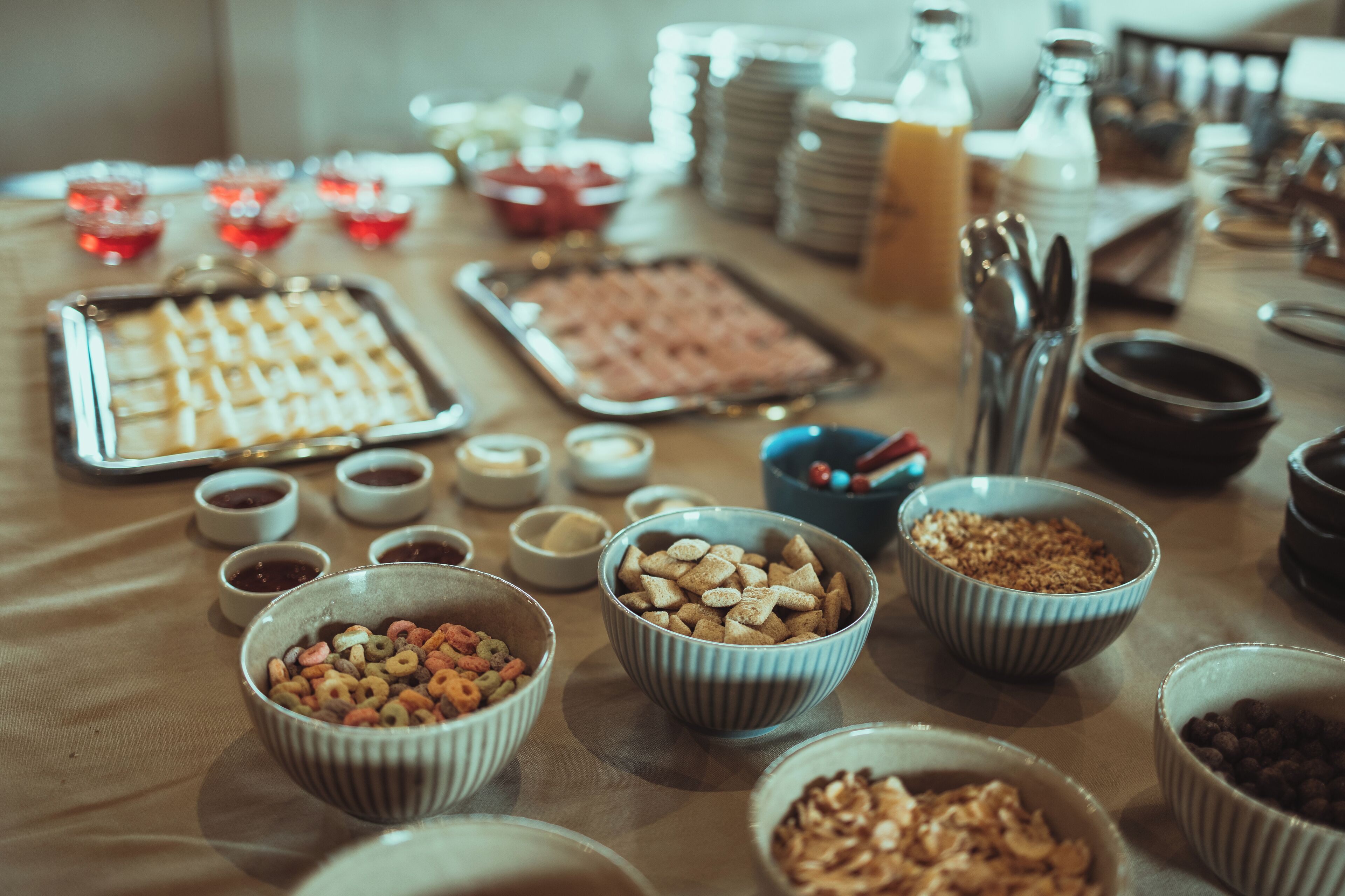 A buffet table with various food items and serving utensils.