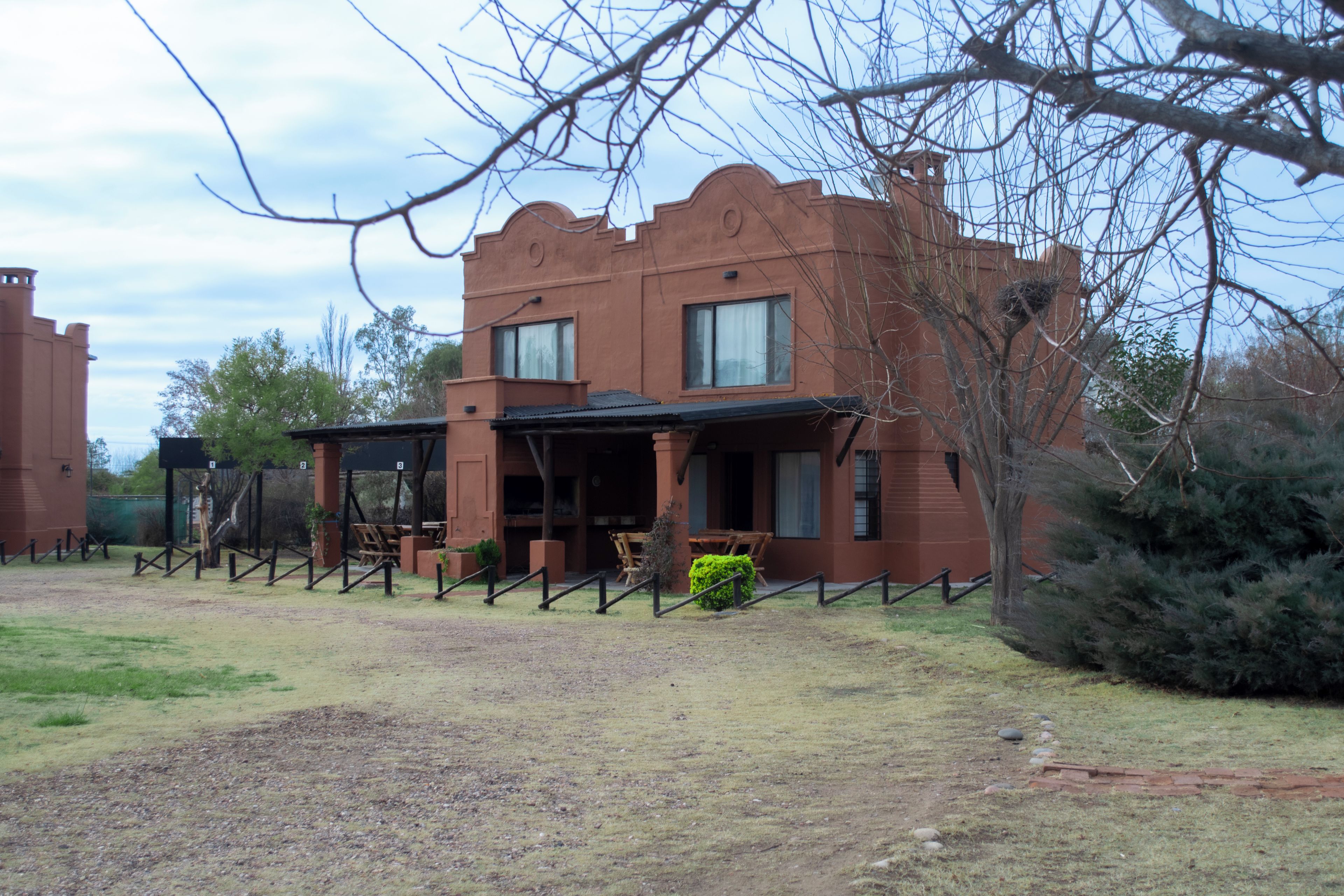 A building with a distinctive architectural style, featuring a flat roof and a symmetrical facade.