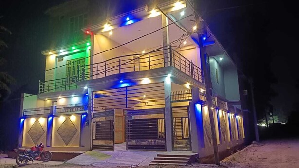 A two-story building with a balcony and a covered entrance area. - VS Grand (Bara Banki)