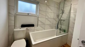 A bathroom with a toilet, sink, and bathtub. - 3 Bedroom Home in Wellington (Wellington)
