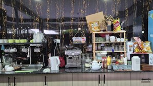 A kitchen counter with various items like a coffee machine, cups, and jars. There is a shelf with snacks and a refrigerator with a Hisense logo. - Bluelight Village Hotel (Nadi)