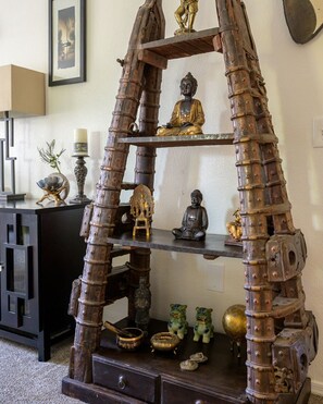 A wooden shelf with various statues and decorative items. - Resort style condo in Scottsdale (Scottsdale)