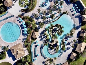 An aerial view of a resort with multiple swimming pools, sun loungers, and palm trees. - Spacious 5 Bed Pool Home With Game Room-1544mvd 5 Bedroom Home (Davenport)