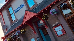 A building with a sign reading "Hillside Hotel" and multiple windows. - Hillside Hotel & Restaurant (Montrose)