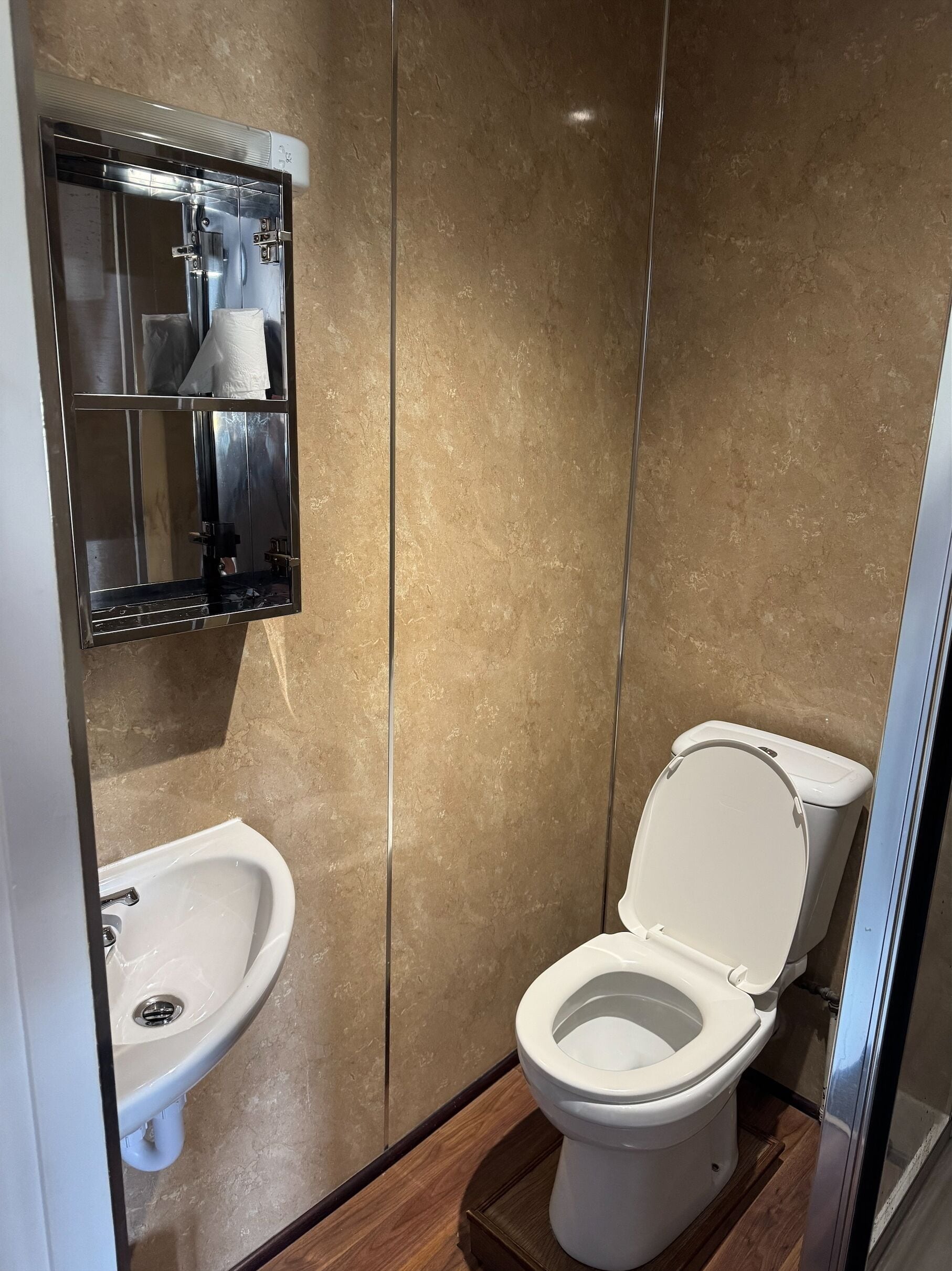 A modern bathroom with a bidet, a toilet, and a sink.